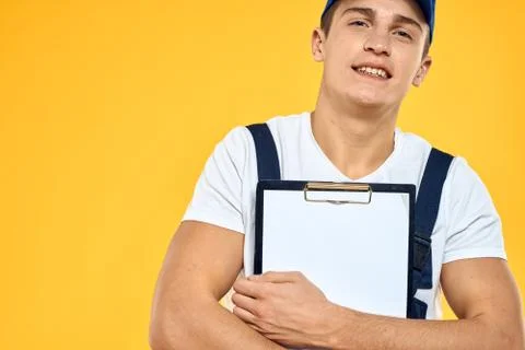 Man in working uniform documents rendering of services delivery service yellow Stock Photos