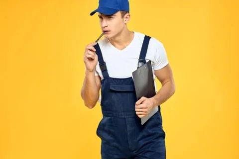 Man in working uniform documents rendering of services delivery service yellow Stock Photos