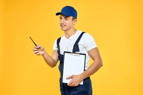 Man in working uniform documents rendering of services delivery service yellow Stock Photos