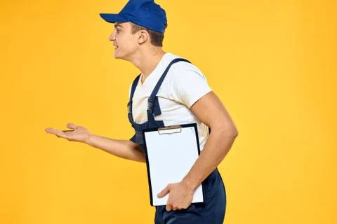 Man in working uniform documents rendering of services delivery service yellow Stock Photos