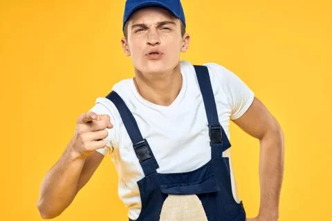 Man in working uniform documents rendering of services delivery service yellow Stock Photos