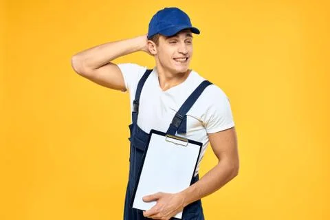 Man in working uniform documents rendering of services delivery service yellow Stock Photos