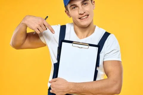 Man in working uniform documents rendering of services delivery service yellow Stock Photos