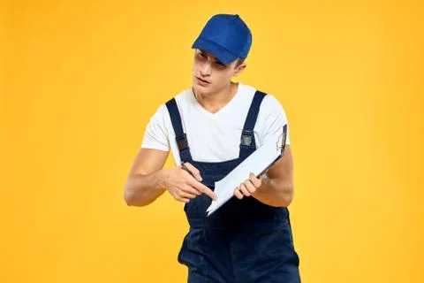 Man in working uniform documents rendering of services delivery service yellow Stock Photos