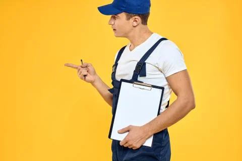 Man in working uniform documents rendering of services delivery service yellow Stock Photos
