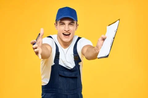 Man in working uniform documents rendering of services delivery service yellow Stock Photos