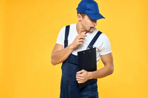 Man in working uniform documents rendering of services delivery service yellow Stock Photos