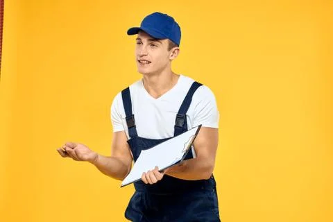 Man in working uniform documents rendering of services delivery service yellow Stock Photos