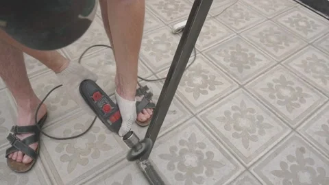 A man in working uniform holds a drill in his hands, which are wearing gloves Vidéo 145182253
