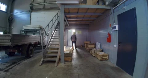 A man in a working uniform walks through the factory Stock Footage 160657552