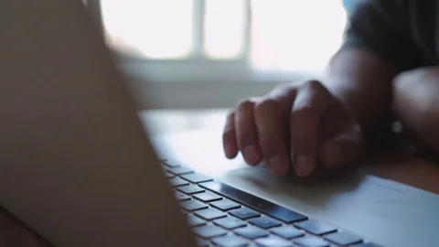 A Man Working Using a Laptop, Browsing Online, Slider Shot Stock Footage 82250633