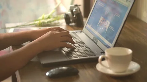 A man is working by using a laptop computer on vintage wooden table. Video stock 60938857
