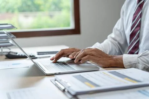 Man working by using a laptop computer Hands typing on keyboard. writing a... Foto stock