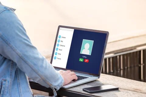 A man is working using laptop doing video call with her friend at outdoor Stock Photos