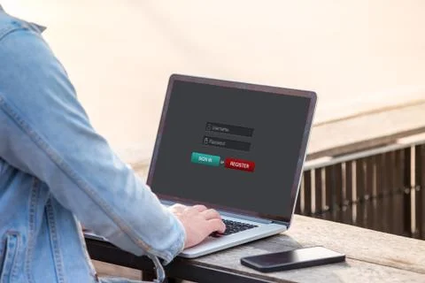 A man is working using laptop doing sign in membership username password on scre Stock Photos