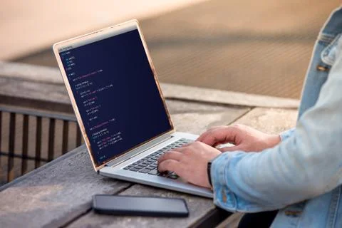 A man is working using laptop doing coding and programming for web development a 库存照片