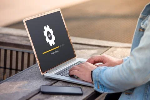 A man is working using laptop doing Installing update process with gearbox perce Stock Photos