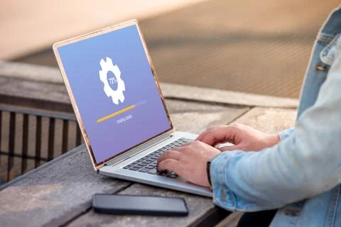 A man is working using laptop doing Installing update process with gearbox perce Stock Photos