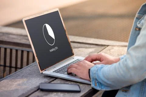 A man is working using laptop doing installing update with circle load percentag Stock Photos