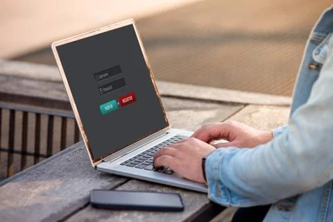 A man is working using laptop doing sign in membership username password on scre Stock Photos