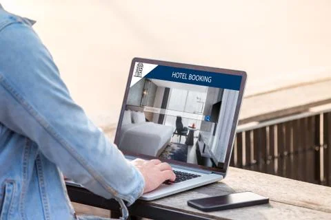 A man is working using laptop, searching for lodging using on-line web service Stock Photos
