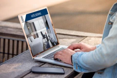 A man is working using laptop, searching for lodging using on-line web service Stock Photos