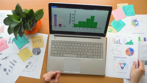 Man working using touchscreen surrounded by a lot of paperwork, hands top view Stock Footage 87383059