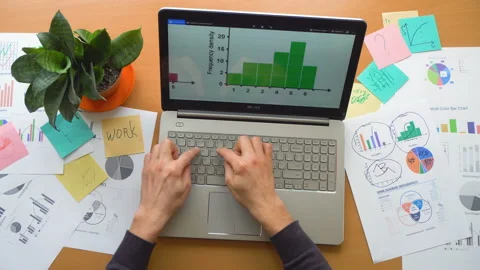 Man working using touchscreen surrounded by a lot of paperwork, hands top view Stock Footage 87383618