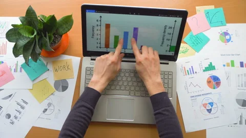 Man working using touchscreen surrounded by a lot of paperwork, hands top view Stock Footage 87779975