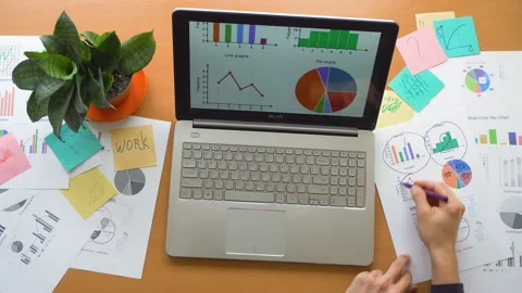 Man working using touchscreen surrounded by a lot of paperwork, hands top view Stock Footage 87780415