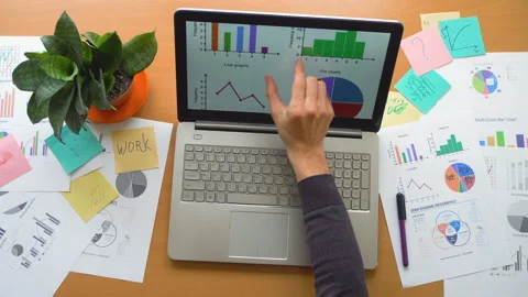 Man working using touchscreen surrounded by a lot of paperwork, hands top view Stock Footage 87873594