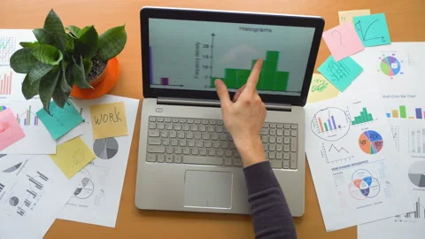 Man working using touchscreen surrounded by a lot of paperwork, hands top view Stock Footage 87976579