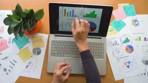 Man working using touchscreen surrounded by a lot of paperwork, hands top view Stock Footage 87976882