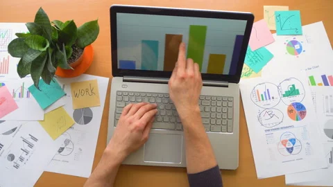 Man working using touchscreen surrounded by a lot of paperwork, hands top view Stock Footage 88164315