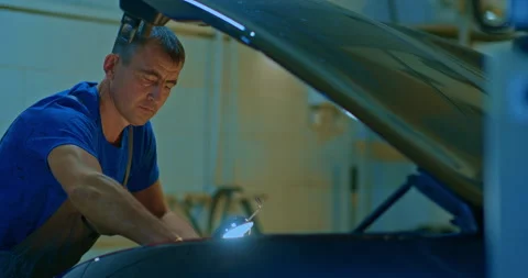 Man is working on an usual car maintenance. Stock Footage 224550304