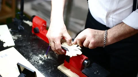 Man is working with vintage tools to make a wooden piece from a plank Stock Footage 62076499