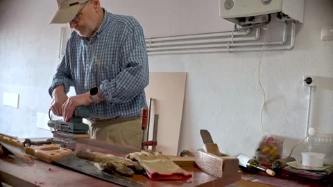 Man Working on a Woodworking Project Using Tools in a Workshop Video stock 312730748