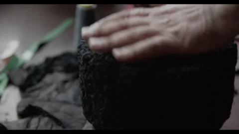 Man working on wool and leather with his hands making a traditional heat. Video stock 271246646