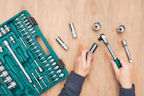 Man working in workshop using many tools. Wrench, spanner, calliper and rat.. Stock Photos