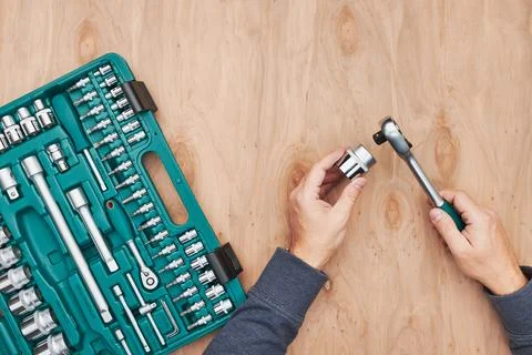 Man working in workshop using many tools. Wrench, spanner, calliper and rat.. Stock Photos