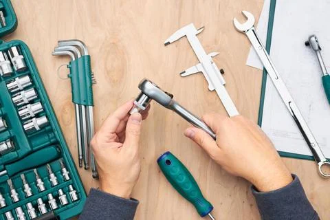 Man working in workshop using many tools. Wrench, spanner, calliper and ra... Stock Photos