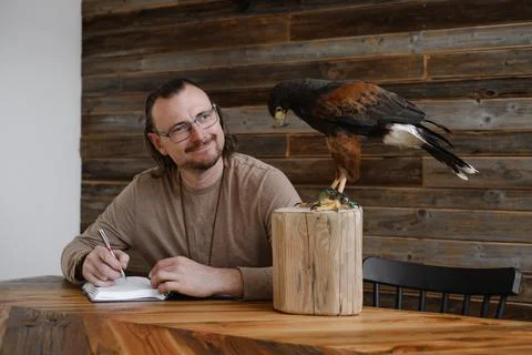 Man is working, writing with wild eagle bird Stock Photos