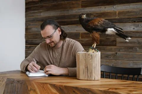 Man is working, writing with wild eagle bird Foto stock