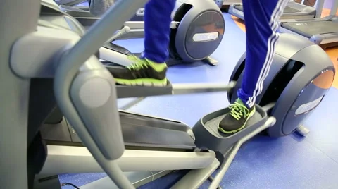 Man workout on elliptical equipmen Stock Footage 46593667
