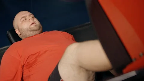 Man workout on leg press exercise machine Stock Footage 108541107