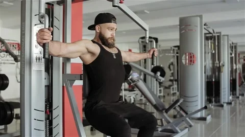 Man workout with Peck-Deck in the gym Stock Footage 56637439