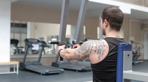 Man workout with power simulator in the gym Stock Footage 62562996