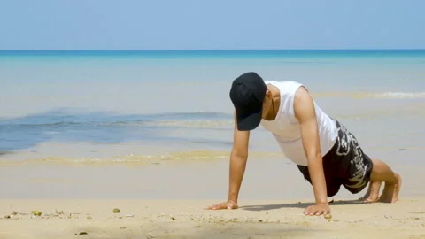 Man workout by push up at the sandy beach, part of his cross fitness workout. Stock Footage 133548179