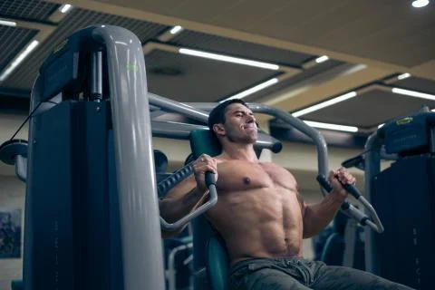 Man workout with simulator in the gym Stock Photos