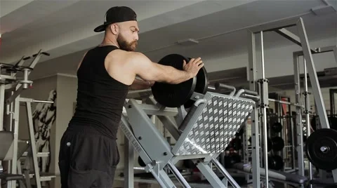 Man workout with simulator leg press in the gym Stock Footage 56635765